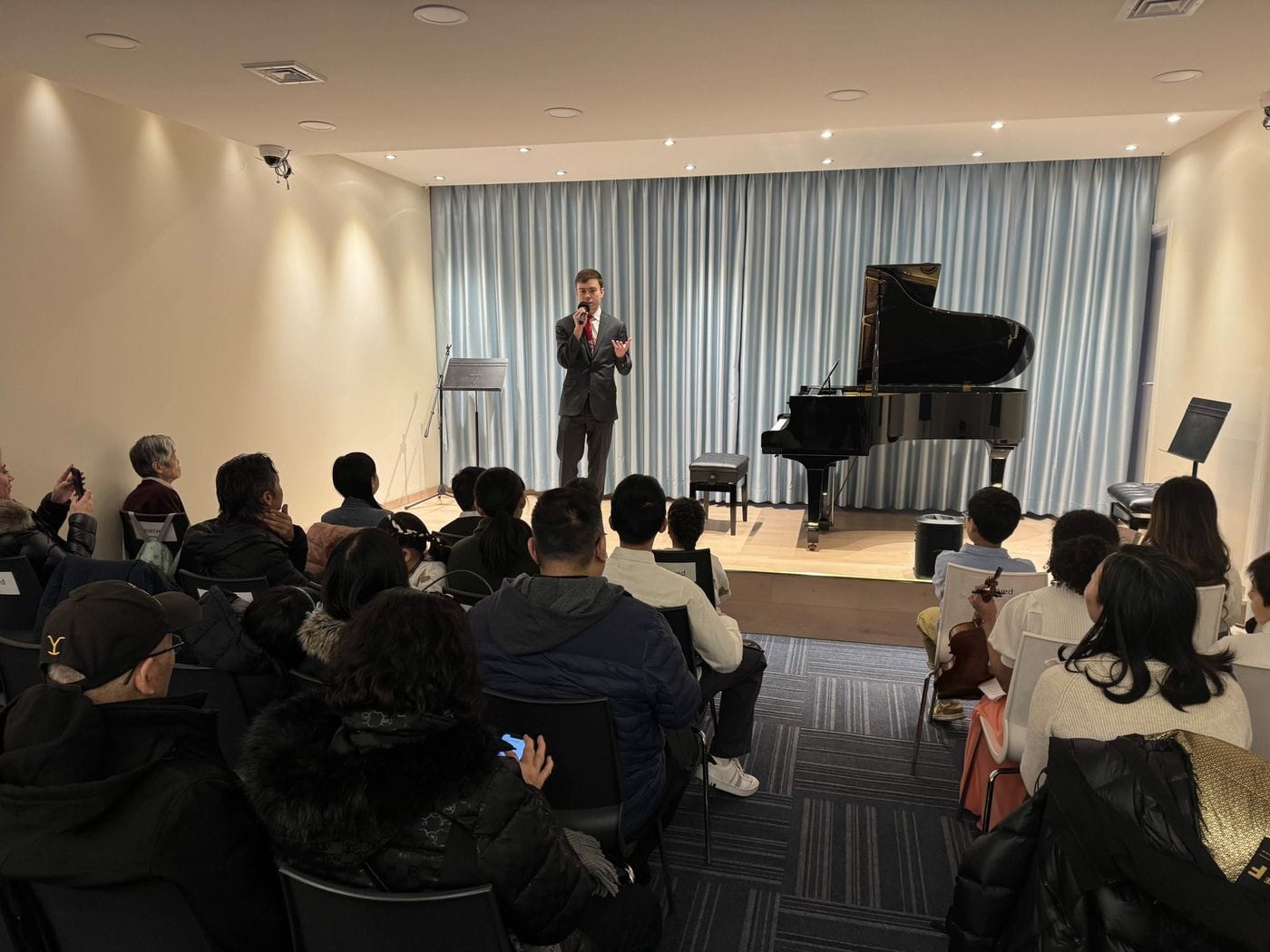 Recital hall with grand piano and audience